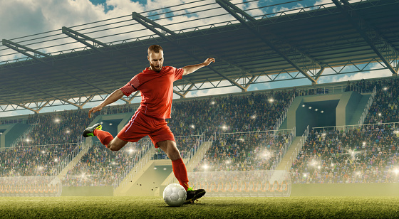 Professional soccer player with a ball in action. Night soccer stadium with fans cheering and dramatic sky. Sports event