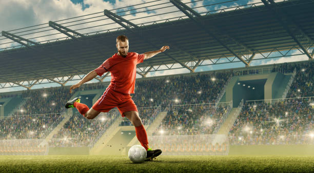 Soccer player in action a stadium Professional soccer player with a ball in action. Night soccer stadium with fans cheering and dramatic sky. Sports event football player stock pictures, royalty-free photos & images