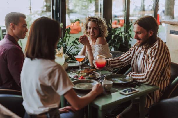 istock Cheerful friends spending time in cozy cafe 1163148259