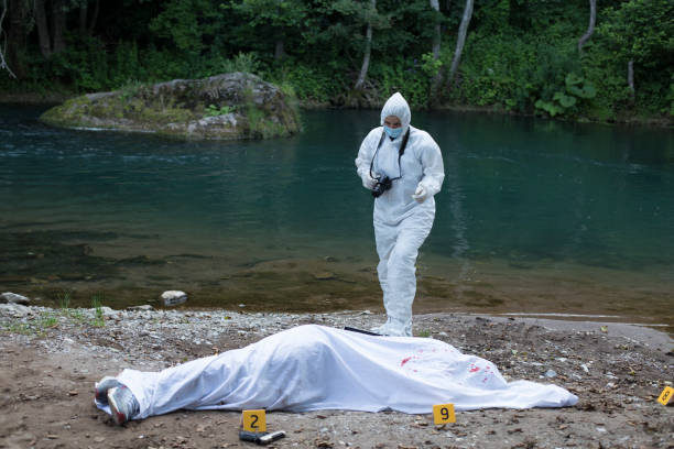 istock Forensic pathologist taking photos of evidence stock photo 1163150370