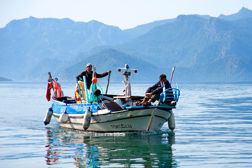 Marmaris, Turkey - March 9, 2012 : Two fisherman coming from fishing