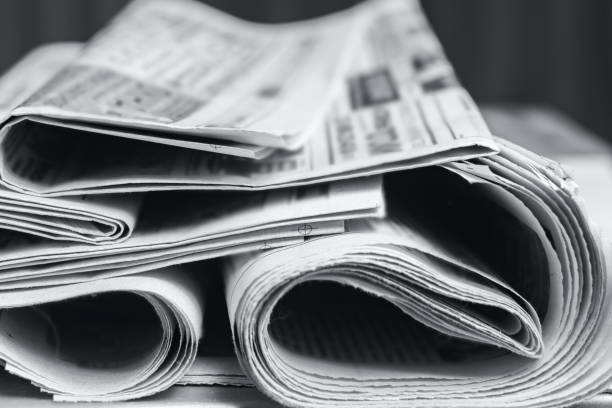 istock News concept, folded newspaper closeup. 1163151854