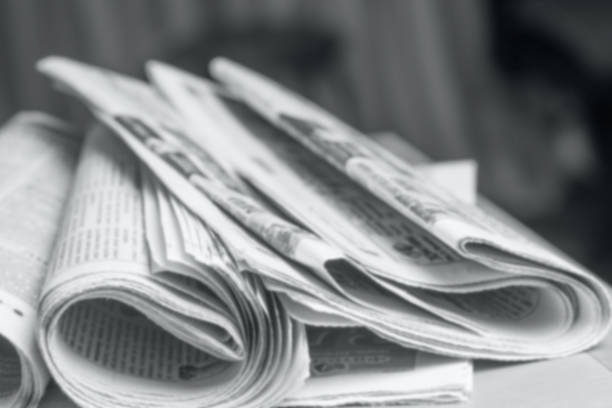 istock News concept, folded newspaper closeup. 1163151859