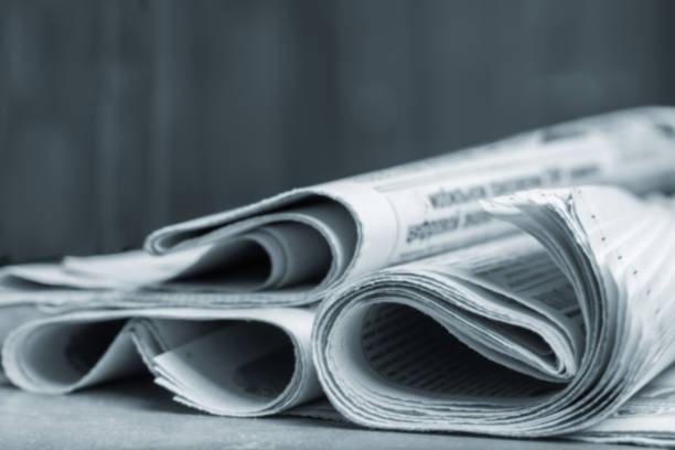 istock News concept, folded newspaper closeup. 1163151886