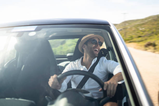 istock Happy man driving car, enjoying vacations 1163152369