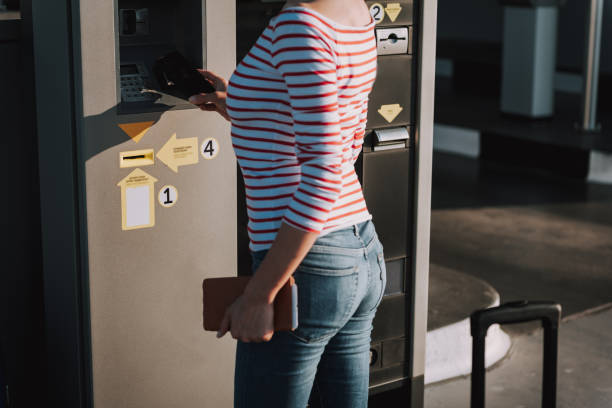 istock Young woman using NFC technology to pay for parking 1163153140