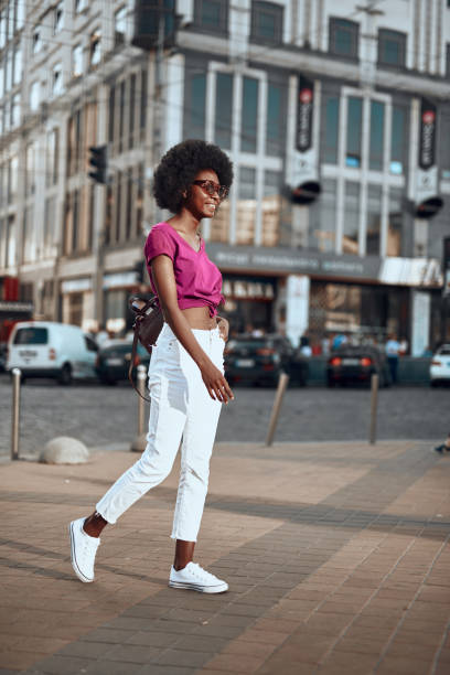 istock Charming and smiling afro-american woman standing outside 1163156754
