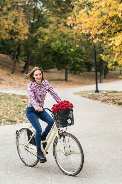 istock Young woman riding a bicycle 1163164325