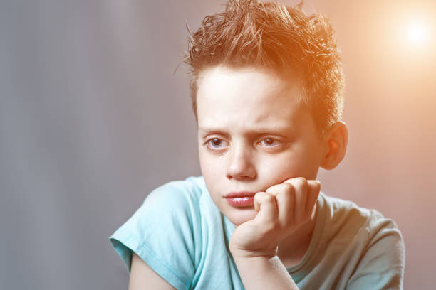 istock a boy in a bright t-shirt offended and crying 1163165317
