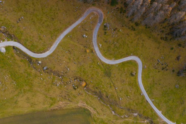 close up part of deserted mountain road through alpine pasture high up in mountains top view nobody