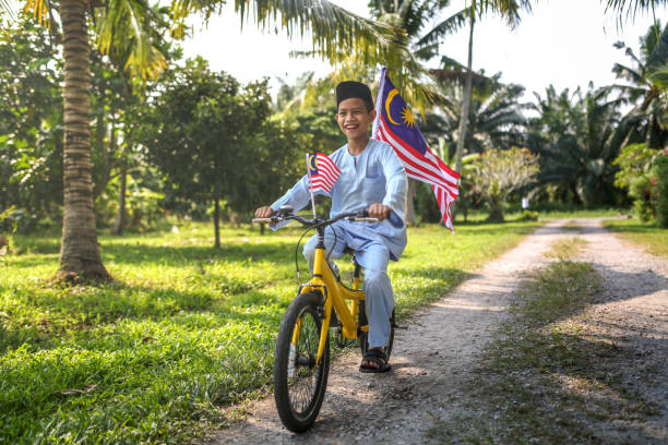 Cute kids cycling with national flag