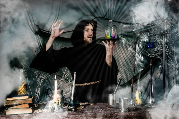 istock The medieval alchemist make magic ritual at the table in his smoke laboratory. 1163170218