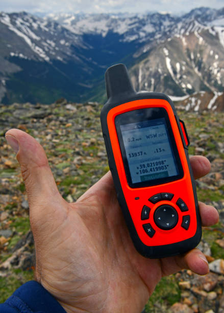 istock Hiker holding GPS navigation device in the mountain wilderness 1163170363