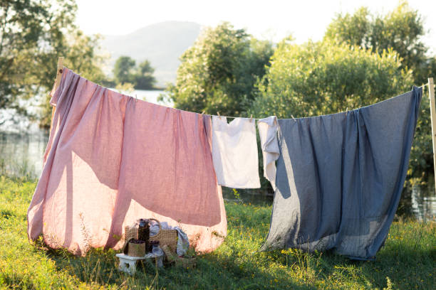 istock Clean bed sheet hanging on clothesline. 1163172255
