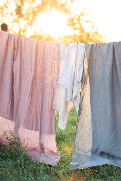 istock Clean bed sheet hanging on clothesline. 1163172256