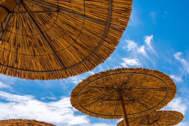 Wicker parasols on beach in Skala Kallonis, Mytilene, (Lesbos), Greece.