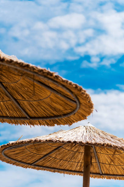 istock Two wicker parasols on beach in Skala Kallonis, Mytilene, (Lesbos), Greece 1163173036
