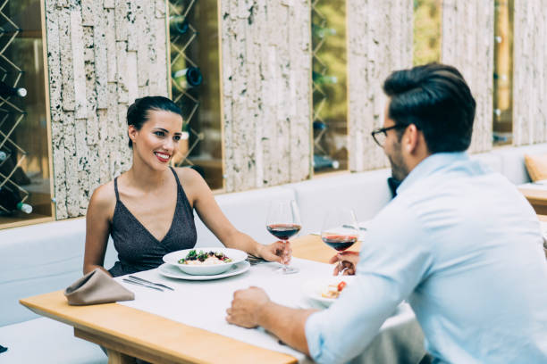 istock Romantic couple eating and drinking wine in restaurant 1163174737
