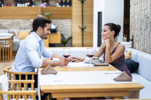 istock Romantic couple dining and talking in restaurant 1163174749