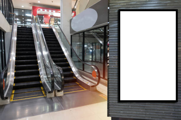 istock blank showcase billboard or advertising light box for your text message or media content in front of escalator in modern department store shopping mall, commercial and marketing concept 1163175804
