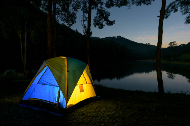 istock Camping and tent near river with view mountain at night. 1163175930