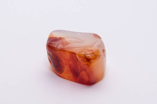 Chinese carnelian gemstone with smooth surface white orange and deep rep tones stock photo