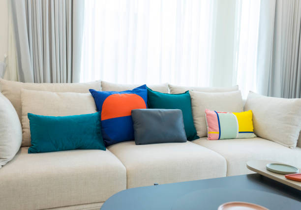istock Large white sofa with colorful cushions in living room interior 1163177516