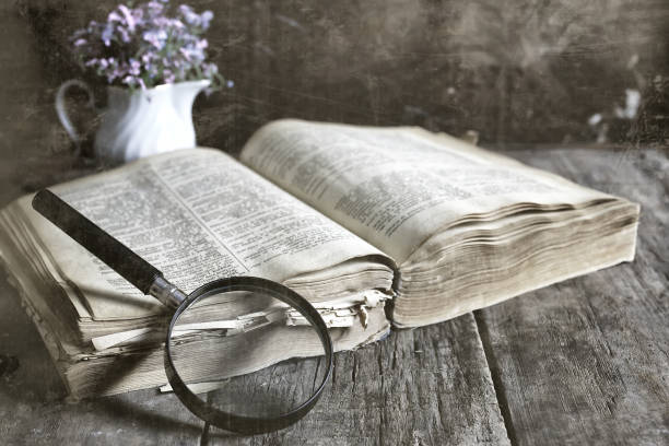 istock old scratched effect on photo magnifying glass and old book 1163177656