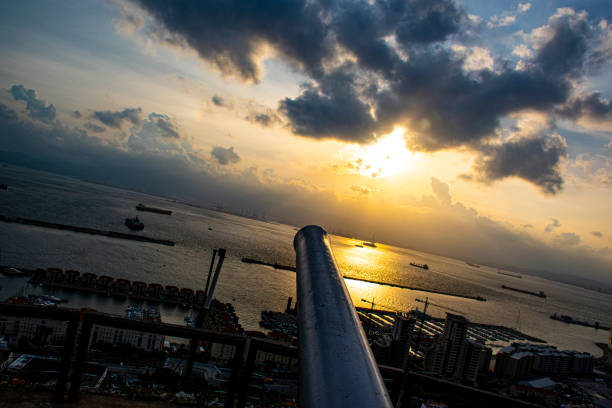 cannon to defend the fortress of Gibraltar with a suggestive sunset over the sea