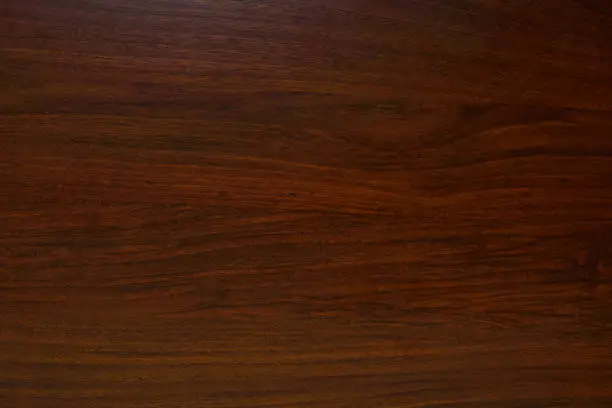 Photo of Polished wood texture. The background of polished wood texture with a dark amber color