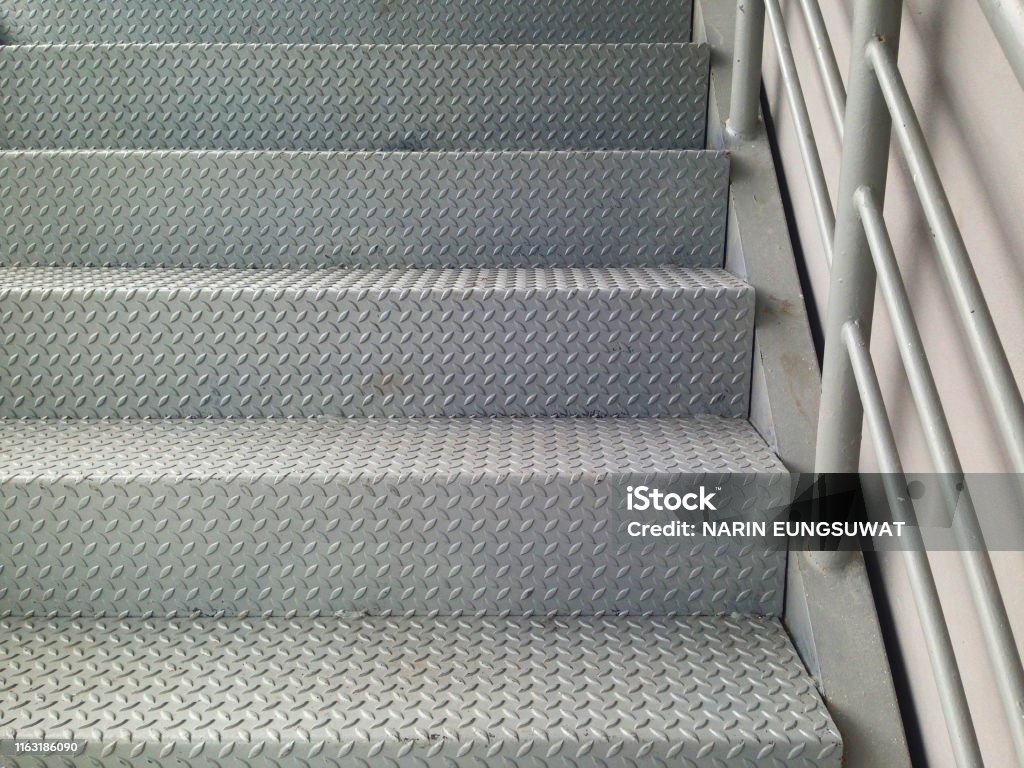 Ladder made of checker plate to increase strength and prevent slipping. Staircase for industrial factory. Staircase Stock Photo