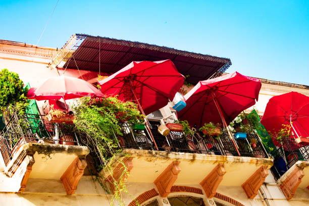 istock Red sun umbrellas on a balcony 1163186547