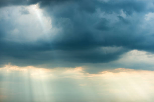 istock Dramatic storm sky with dark clouds and bright sunbeams 1163187642
