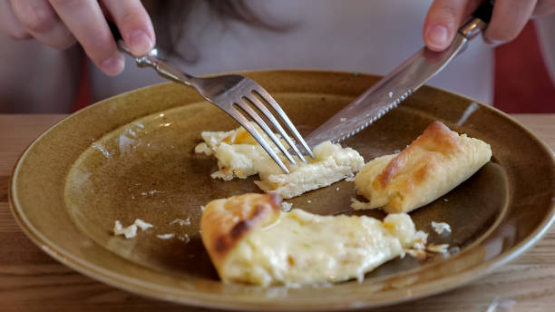 istock girl cuts khachapuri into pieces 1163188710