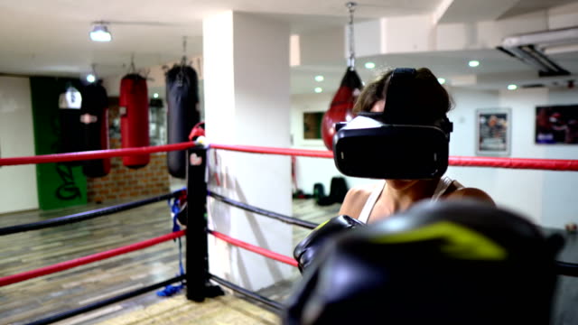 Female boxer training with Virtual reality headset - video game