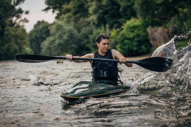istock Woman in a kayak sails on swift river 1163192250