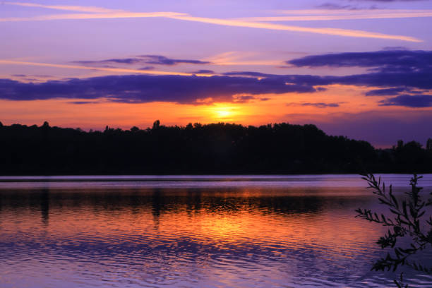 istock Sunset in a colorful romantic setting at the water's edge. 1163193822