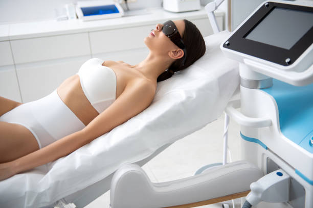 istock Young lady lying in laser cosmetic center 1163194180