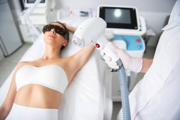 istock Specialist hold laser hair removal device in hand 1163194717