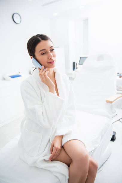 istock Lady in cosmetic center talking by mobile phone 1163196916