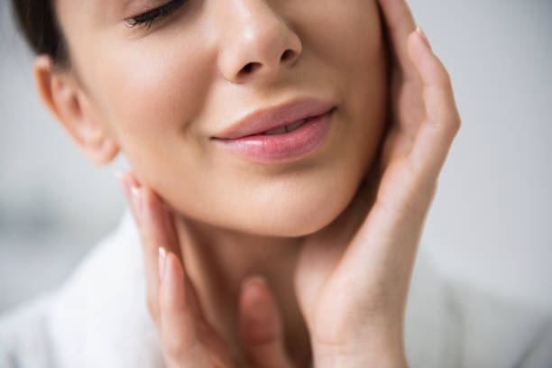 istock Close up smiling lady enjoying her soft skin 1163196943