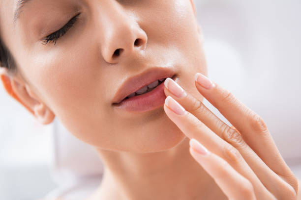 istock Close up lady enjoying touching her plush lips 1163196948