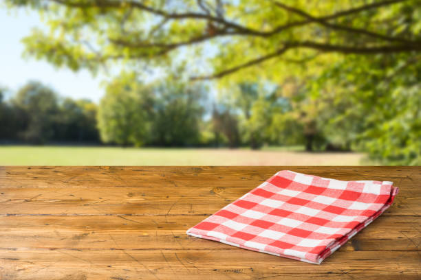 istock Empty wooden table with tablecloth over autumn nature park background 1163201123