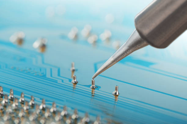 Soldering of electronic circuit board with electronic components. Soldering station. Engineers repair circuit board with soldering iron.