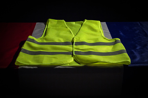 Yellow vest on French flag. Yellow vests protests  in France concept.