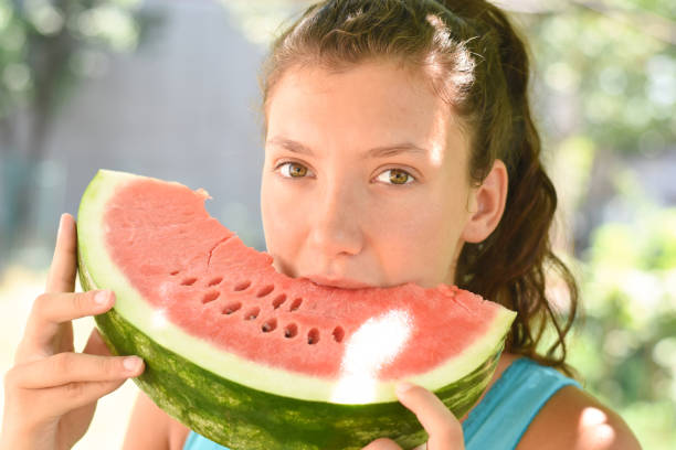 istock Girl eating watermelon 1163204730