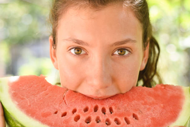 istock Girl eating watermelon 1163205409