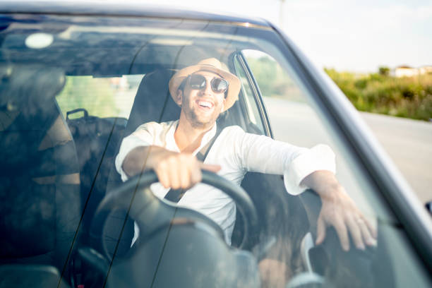 istock Happy man driving car, enjoying vacations 1163205929