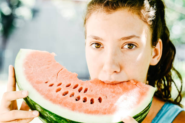 istock Girl eating watermelon 1163207227