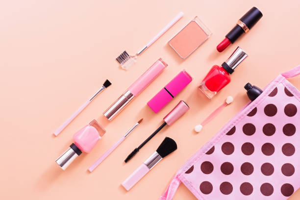 istock Various women's makeup cosmetics on a soft pink background. Cosmetic bag, blusher, mascara, lipstick, nail polish and brushes. Top view, flat lay, copy space. 1163208774